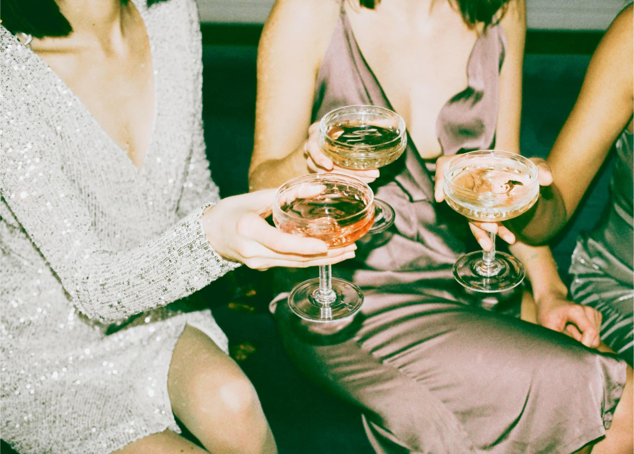 Group of female friends celebrating with a cocktail after signing up to the Bustly waitlist.
