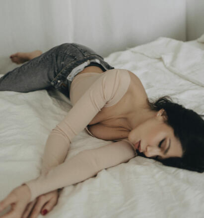 Side sleeping woman Women in bed sleeping on her side which is creasing her chest skin.